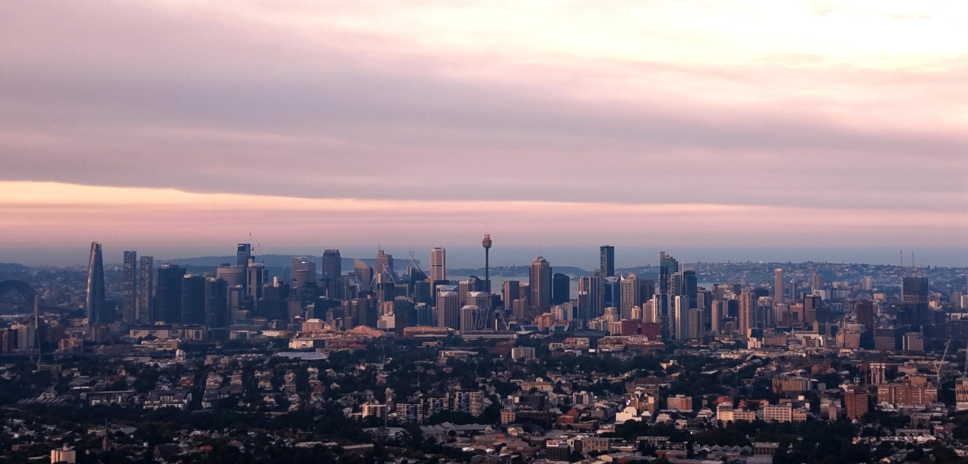 Panoramic aerial view of the Sydney CBD skyline at sunset from the Inner West